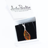 Striking and elegant Cognac Amber Pendant featuring silver and amber