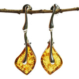Pretty shaped honey or cherry coloured amber drop earrings